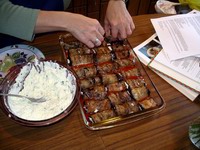 filling a tray with eggplant rollatini