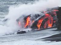 red lava flowing into the ocean